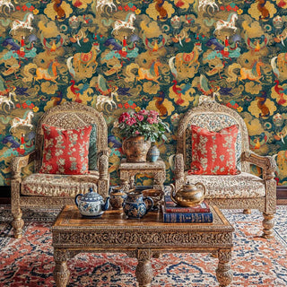 Traditional mythical wallpaper with golden creatures on teal, shown in formal sitting area with twin chairs