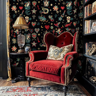 Traditional tattoo art wallpaper featuring mermaids and stars, displayed in library with red velvet chair