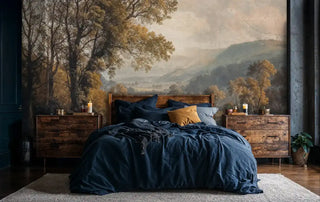 Tranquil pastoral wallpaper with golden trees and rolling hills, featured in cozy bedroom with navy blue bedding