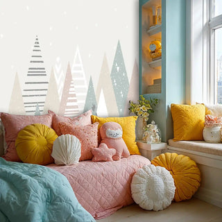 Triangular mountain wallpaper in soft pastels, shown in comfortable reading nook with colorful cushions