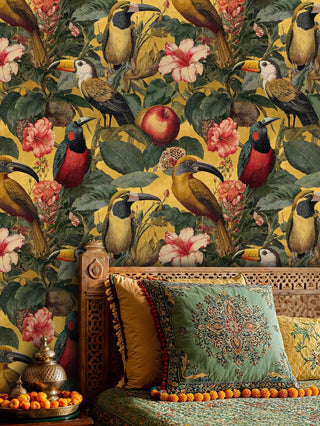 Tropical bird wallpaper on golden ground, in a boho lounge with carved daybed and ornate cushions