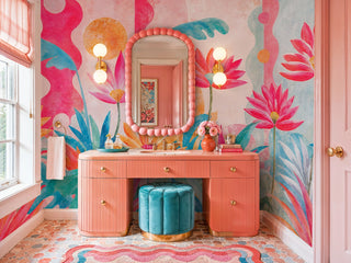 Tropical bloom wall mural in pink and aqua watercolor style in a powder room with coral vanity and teal stool