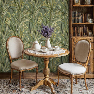Tropical botanical wallpaper featuring golden palm fronds in dining room with antique chairs