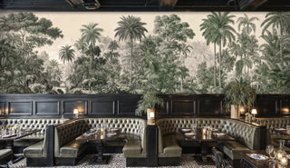 Tropical elephant wall mural with dense palm trees in green tones, shown in a dimly lit restaurant with leather booths