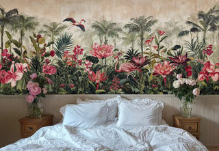 Tropical flamingo wall mural with coral florals and palms shown in cozy bedroom with white bedding and wooden nightstands