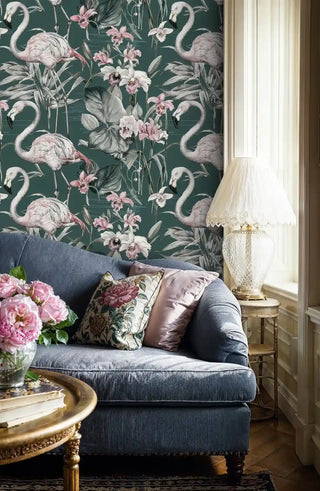 Tropical flamingo wallpaper with pink birds and exotic blooms on emerald background in elegant living room with navy sofa