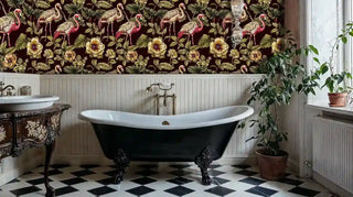 Tropical flamingo wallpaper with pink birds and golden flowers on burgundy, shown in elegant bathroom with clawfoot tub
