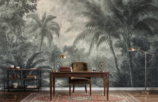 Tropical jungle etching wall mural with palm trees and misty river in green and beige, in a study with brass lamp