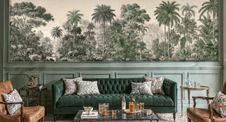 Tropical jungle wall mural with elephants and palms in green engraving style, shown in a classic room with green tufted sofa