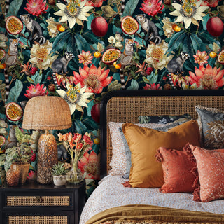 Tropical lemur wallpaper with passion flowers and exotic fruits in a maximalist bedroom with cane headboard