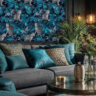 Tropical leopard wallpaper featuring spotted cats in teal jungle foliage, displayed in modern living room with grey sofa