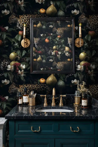Tropical leopard wallpaper with spotted cats and fruit motifs, shown in luxury bathroom with black marble vanity