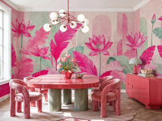 Tropical lotus wall mural in pink and mint tones with lush foliage, displayed in a bold dining room with coral table