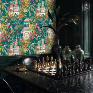 Tropical palace wallpaper with ornate temples and lush botanicals in teal and coral, displayed in elegant study with chess