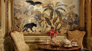 Tropical paradise wall mural with exotic birds and panthers, shown in an ornate sitting room with floral tea set