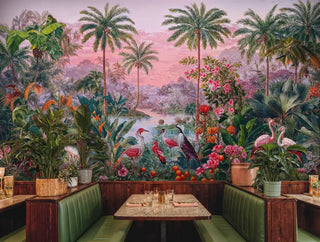 Tropical paradise wall mural with flamingos and palm trees, displayed in cozy restaurant booth with green banquettes