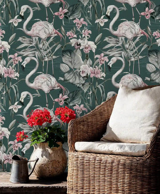 Tropical paradise wallpaper showing flamingos and exotic blooms in rustic room with wicker chair and red flowers