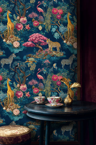 Tropical paradise wallpaper with safari animals and vibrant flowers, shown in sophisticated dining nook with dark wooden table