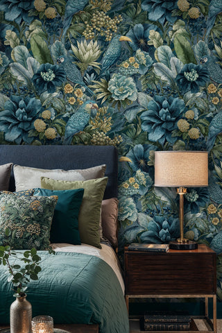Tropical parrot wallpaper in teal and green tones displayed behind a bedroom with teal bedding and wooden nightstand