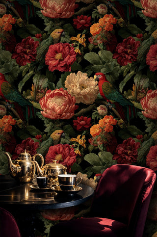 Tropical parrot wallpaper with colorful birds and coral blooms on black, in luxurious dining with gold tea set