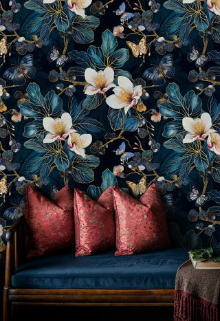 tropical wallpaper with golden butterflies and leaves in bedroom with burgundy velvet pillow