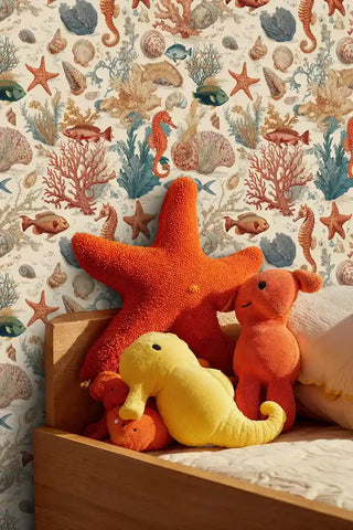 Underwater themed wallpaper showing seahorses and starfish, featured in playroom with colorful sea creature toys on shelf