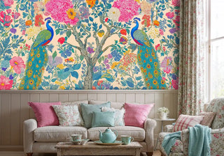 Vibrant peacock botanical wall mural with floral details, displayed in cottage-style living room with floral armchair