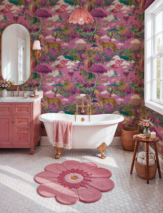 Vibrant pink safari wallpaper with tigers and clouds in a bathroom with clawfoot tub and flower rug