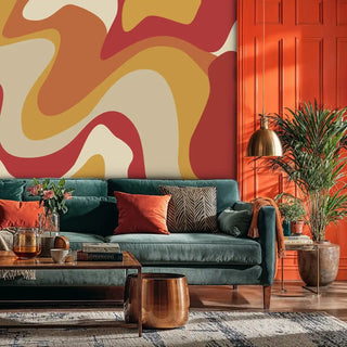 Vibrant retro wallpaper with warm tones in stylish living space with teal sofa and orange cabinets