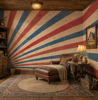 Vintage Americana sunburst wall mural with red blue cream rays and stars in a rustic den with leather chaise
