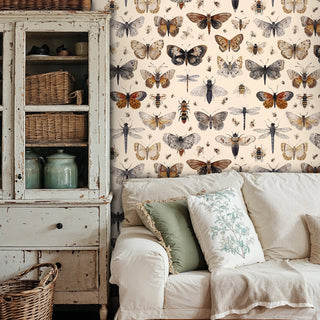 vintage butterfly wallpaper with moths and dragonflies, featured in cozy living room with armchair