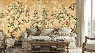 Vintage Chinoiserie Wall Mural with birds and pink flowers on a gold background, behind a cozy off-white sofa in a farmhouse room.