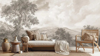 Vintage landscape wall mural with detailed tree and mountain scenery shown in cozy living room with woven chair and natural textures