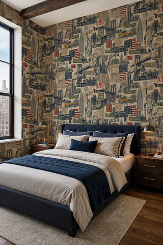 Vintage NYC skyline wallpaper with postage stamps and street signs, shown in a loft bedroom with a navy upholstered bed
