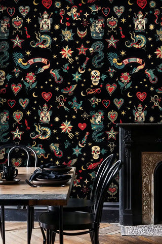 Vintage tattoo wallpaper showing sacred hearts and stars, displayed in kitchen with black dining set