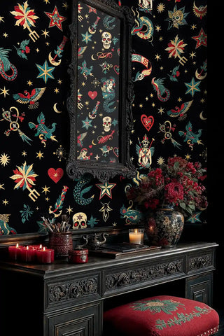 Vintage tattoo wallpaper with skulls, hearts, and serpents in black and gold, shown with ornate mirror