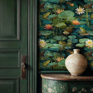 Water garden wallpaper with frogs on lily pads and cream flowers, shown beside green paneled door and ceramic vase