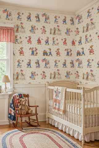 Watercolor children parade wallpaper in red blue and cream, shown in a nursery with wooden crib and rocking chair