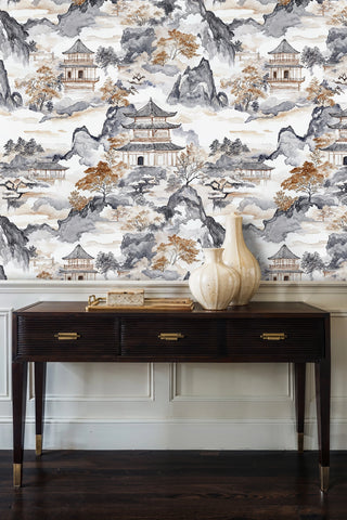 Watercolor mountain temple wallpaper shown in an elegant entryway with dark console table and brass hardware