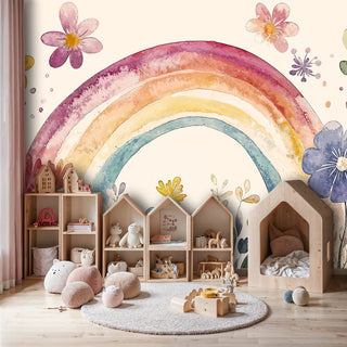 Watercolor rainbow floral wall mural with vibrant arch and wildflowers in a playful kids room with wooden toys