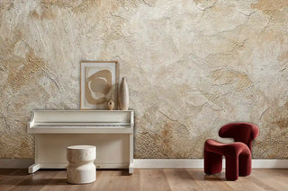 Weathered plaster texture wall mural creating authentic backdrop, styled with white piano and red chair