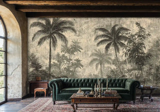 Weathered tropical wall mural showing palm groves, displayed in rustic living room with green chesterfield sofa