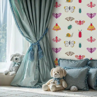 Whimsical butterfly and bug wallpaper displayed in elegant nursery with blue curtains and teddy bears