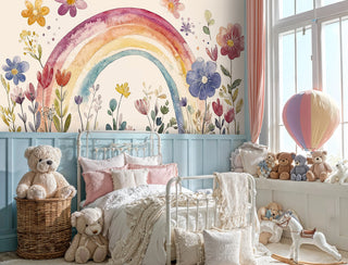 Whimsical floral rainbow wallpaper with watercolor blooms in a child's bedroom with vintage metal bed frame