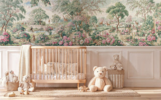 Whimsical garden wall mural with pink flowers and giraffes in a nursery with wooden crib and teddy bears