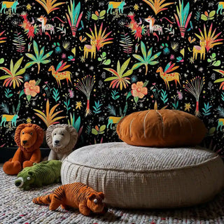 Whimsical safari wallpaper featuring vibrant animals and botanical prints, shown in kids room with gray bean bag and plush toys