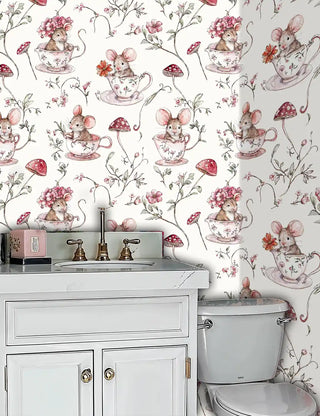 Whimsical teacup mice wallpaper with botanical elements in bathroom with white marble vanity and gold fixtures