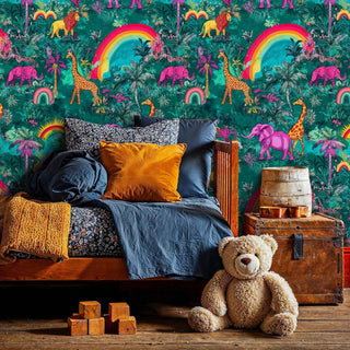 Whimsical tropical wallpaper with safari animals and colorful rainbows, shown in cozy bedroom setting