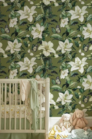 White lily botanical wallpaper with monarch butterflies, shown in nursery with white crib and toys