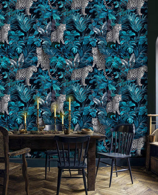Wild leopard wallpaper with spotted cats in tropical foliage, shown in rustic dining room with wooden table